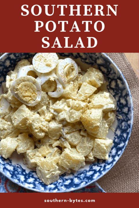 A pin image of a bowl of homemade potato salad with pickles and celery topped with hard-boiled eggs.