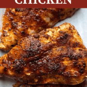 A pin image of a plate of cooked cajun blackened chicken.