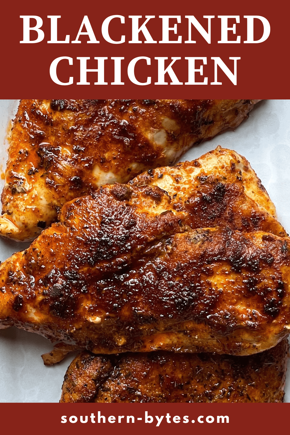 A pin image of a plate of cooked cajun blackened chicken.