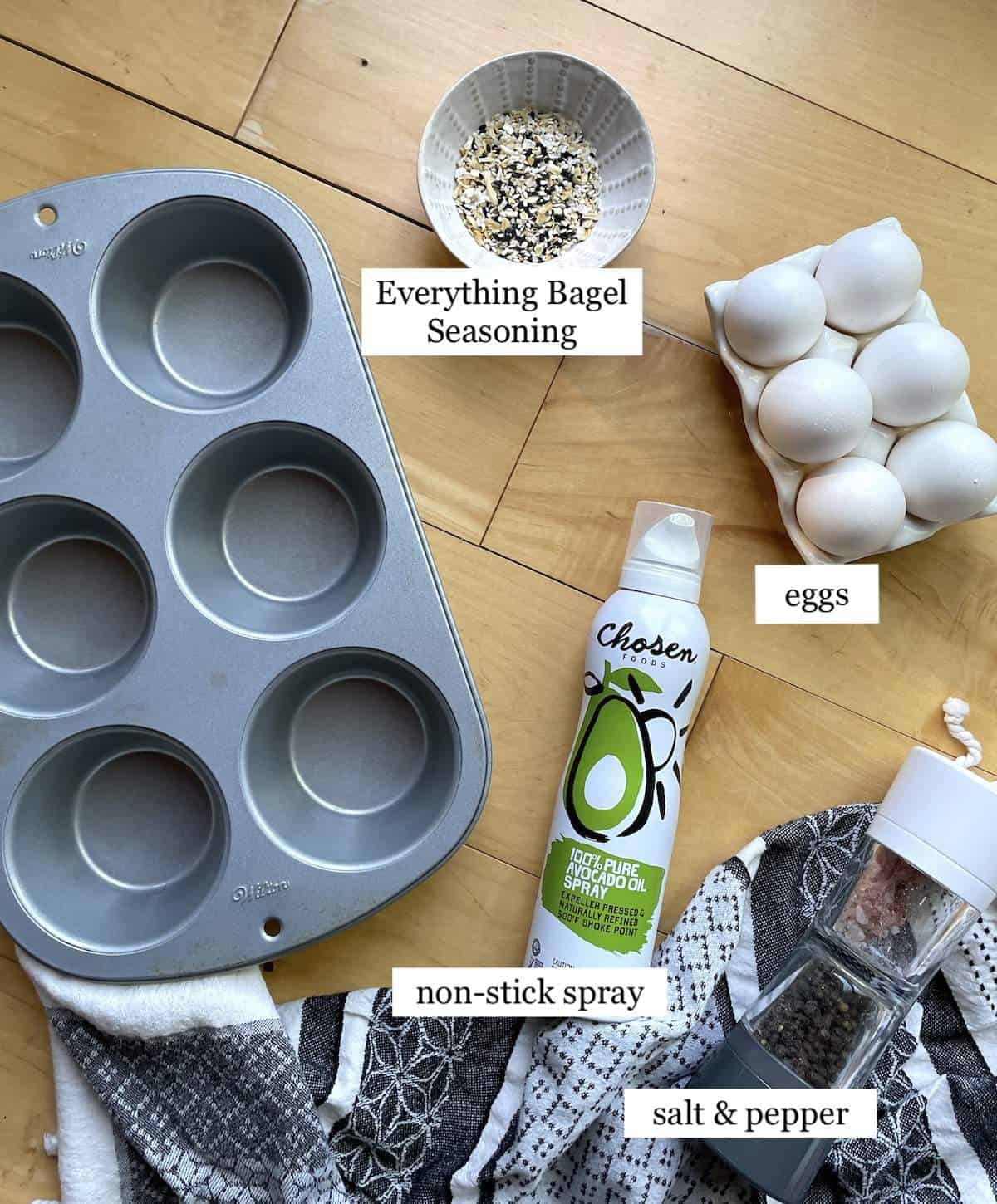 The ingredients needed to bake eggs in a muffin tin, laid out and labeled.