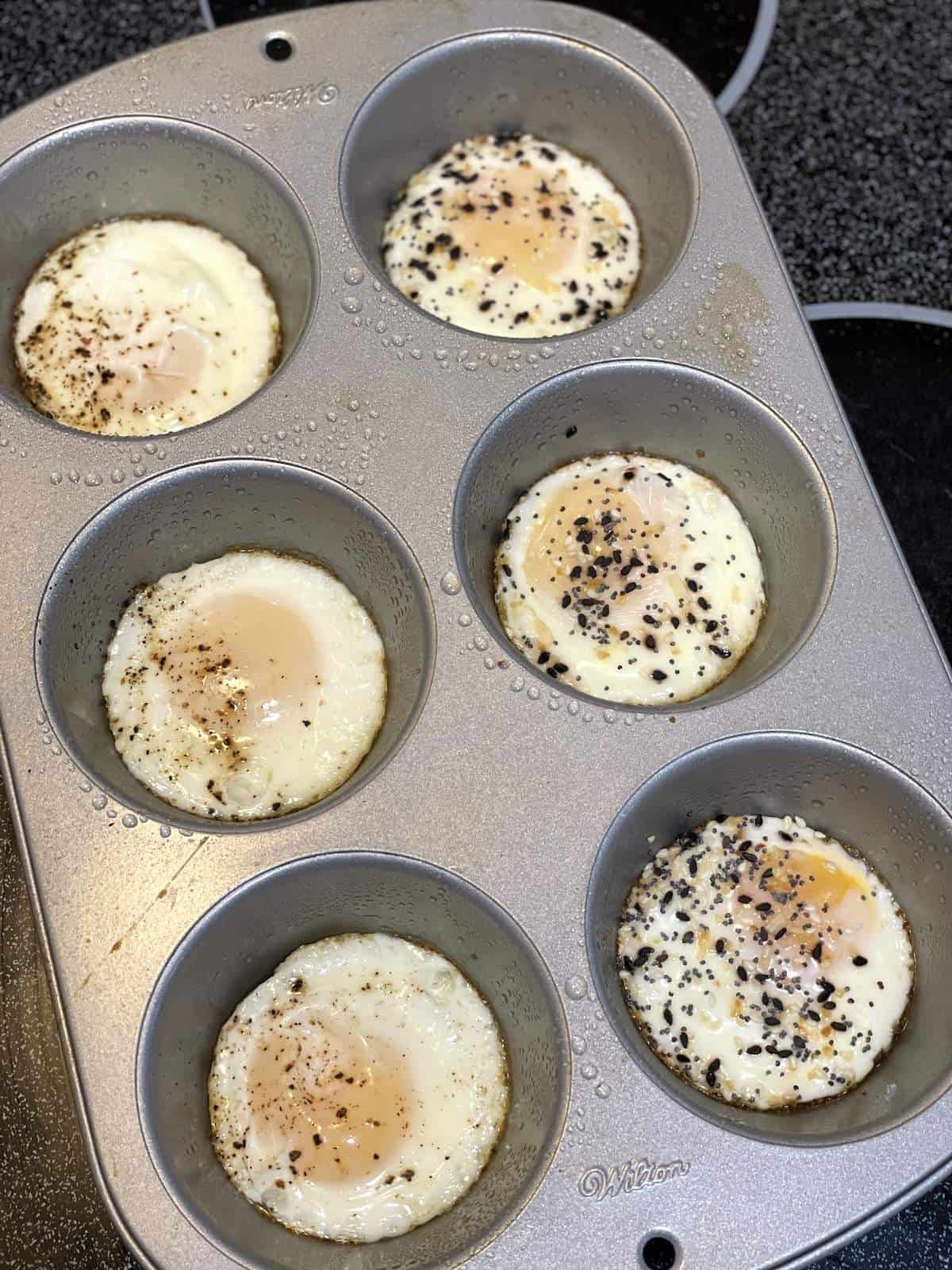 A muffin tin with eggs baked in the individual cups.