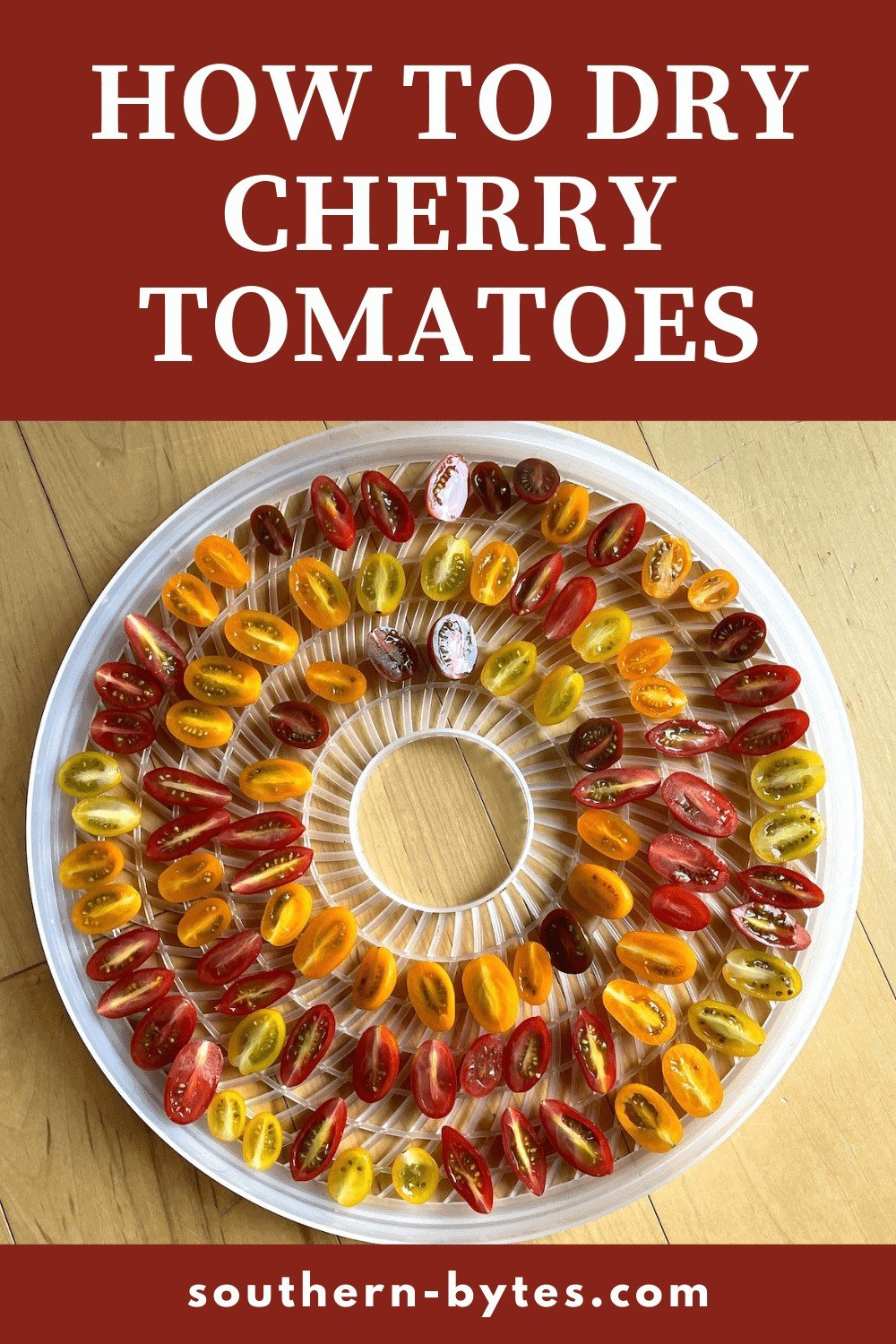 A pin image of a dehydrator tray covered in sliced cherry tomatoes.