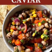 A pin image of a small bowl of redneck caviar with black-eyed peas, black beans, corn, tomatoes, red onions, and cilantro with a vinegar based dressing and a side of tortilla chips.