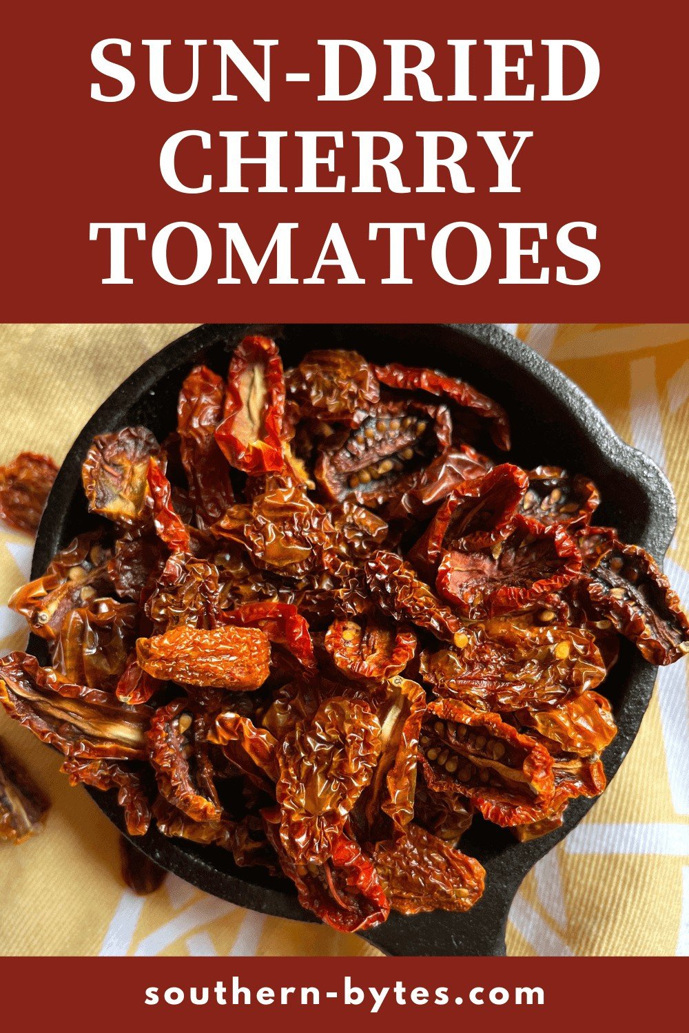 A pin image of a tiny cast iron pan filled with sun-dried cherry tomatoes.