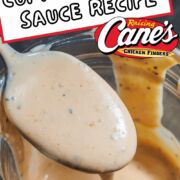 A pin image of orange, peppery Cane's Sauce dripping off of a spoon into a mason jar.