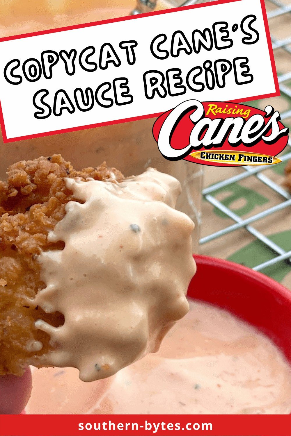 A pin image of a buttermilk fried chicken tender covered in peppery Cane's sauce.