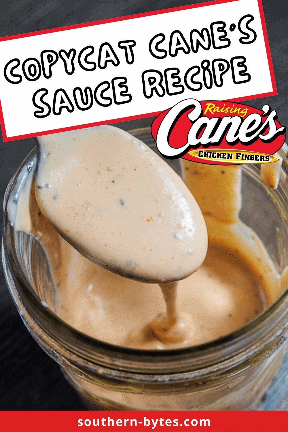 A pin image of creamy, tangy Cane's Sauce dripping off of a spoon into a mason jar.