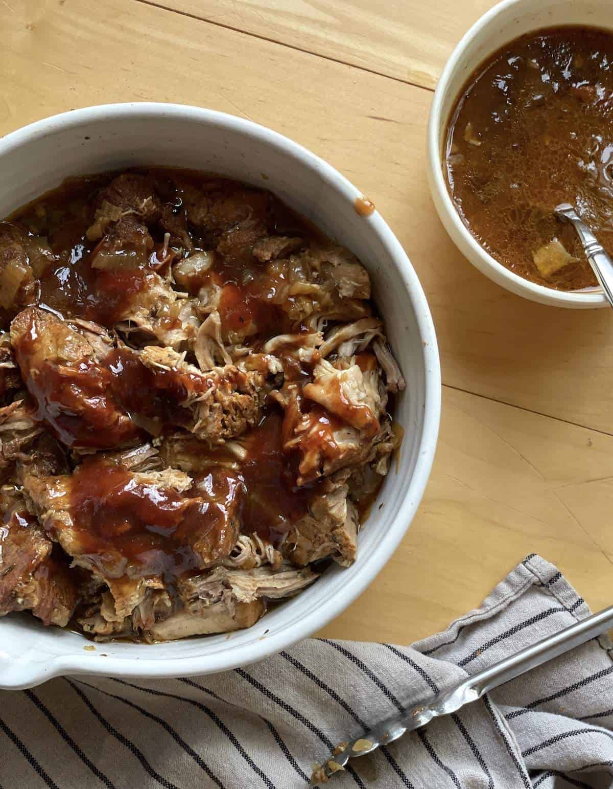 A white bowl of instant pot country style boneless pork ribs coated in barbecue sauce.
