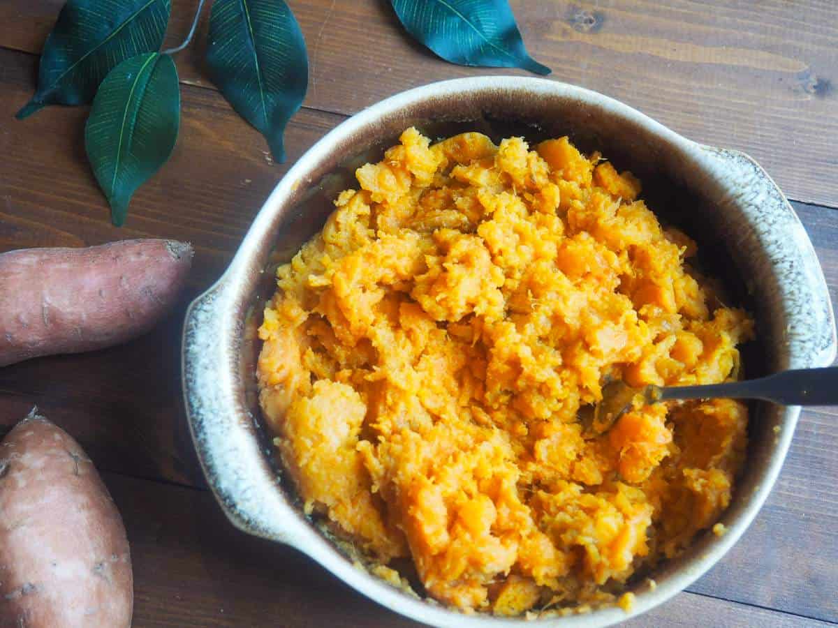 A bowl of chunky mashed Instant Pot sweet potatoes.
