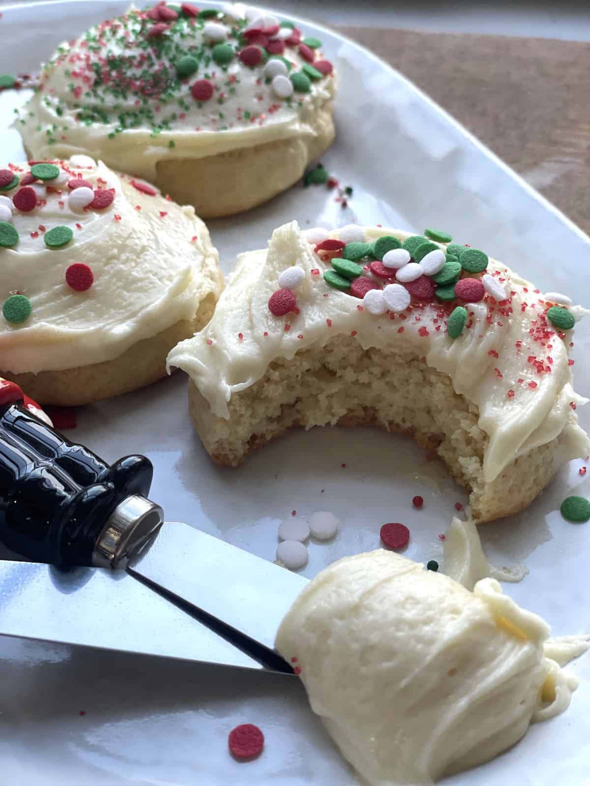 Frosted buttermilk cookies with Christmas sprinkles and nutcracker knives with extra frosting.