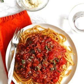 A plate of crockpot spaghetti sauce served over spaghetti.