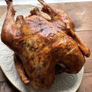 A dry brined turkey with crispy skin on a platter.