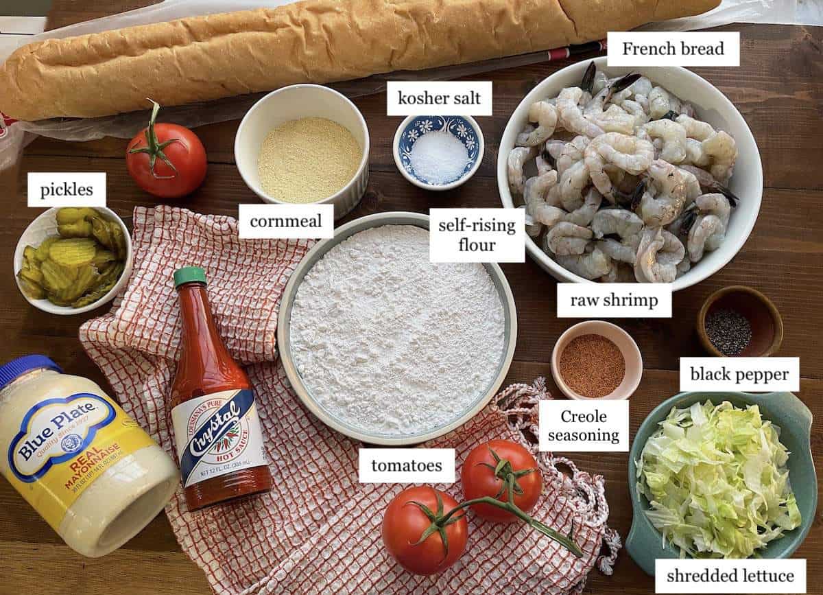 The ingredients needed to make fried shrimp po boys, laid out and labeled.