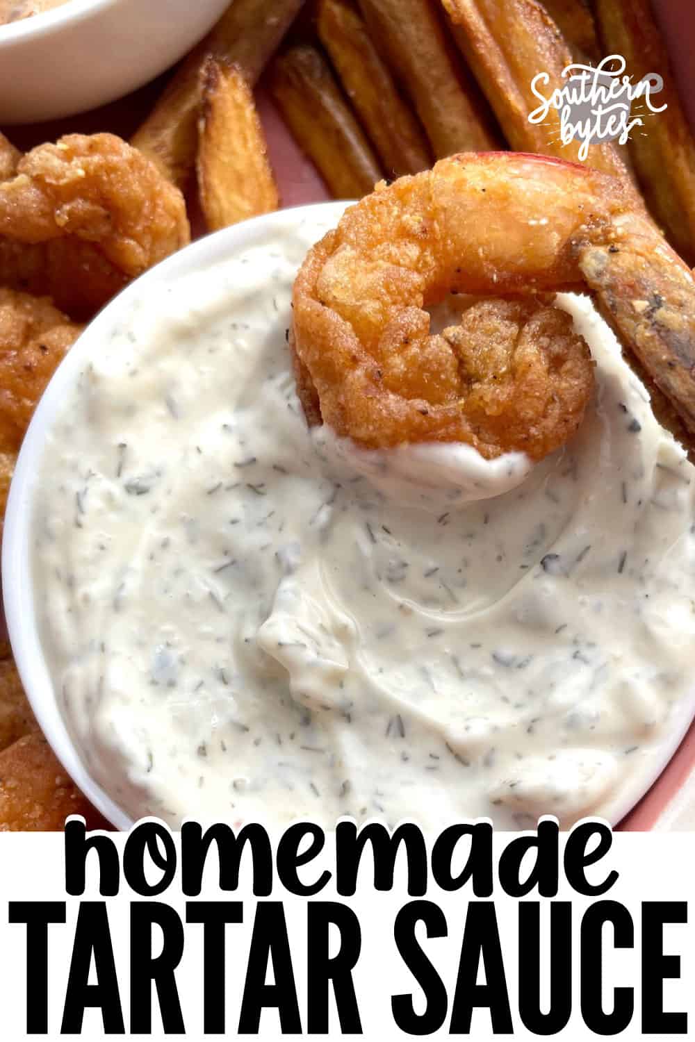 A pin image of a bowl of tartar sauce with a fried shrimp in it.