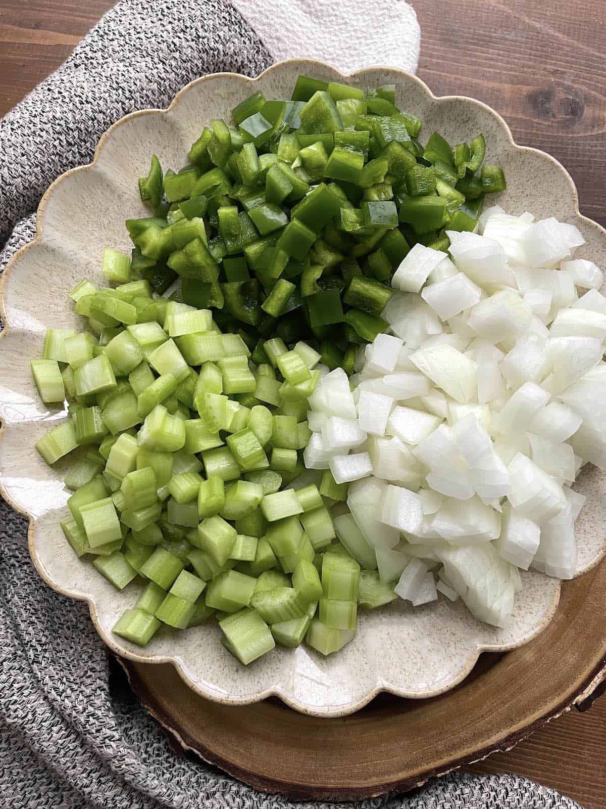 A plate with the creole holy trinity on it - diced onions, celery, and green bell peppers.