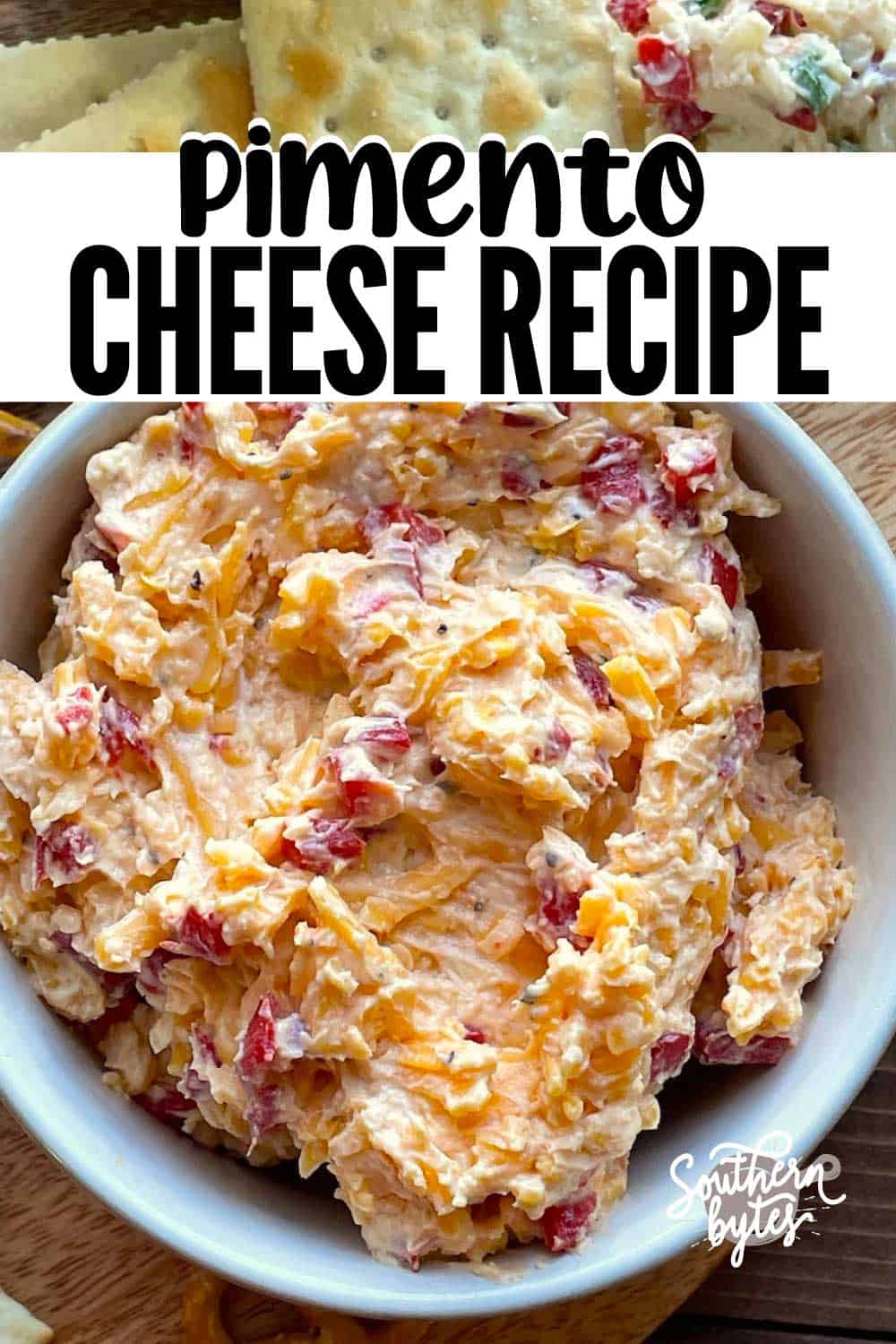 A pin image of a white bowl of homemade pimento cheese surrounded by crackers.