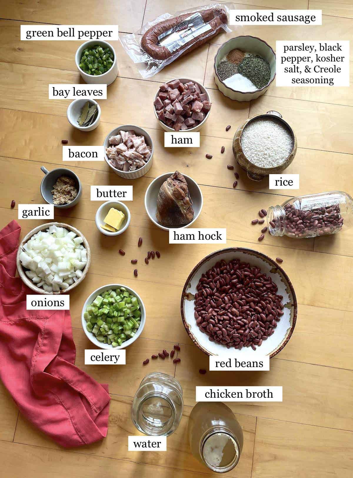 The ingredients needed to make red beans and rice, laid out in small bowls and labeled.