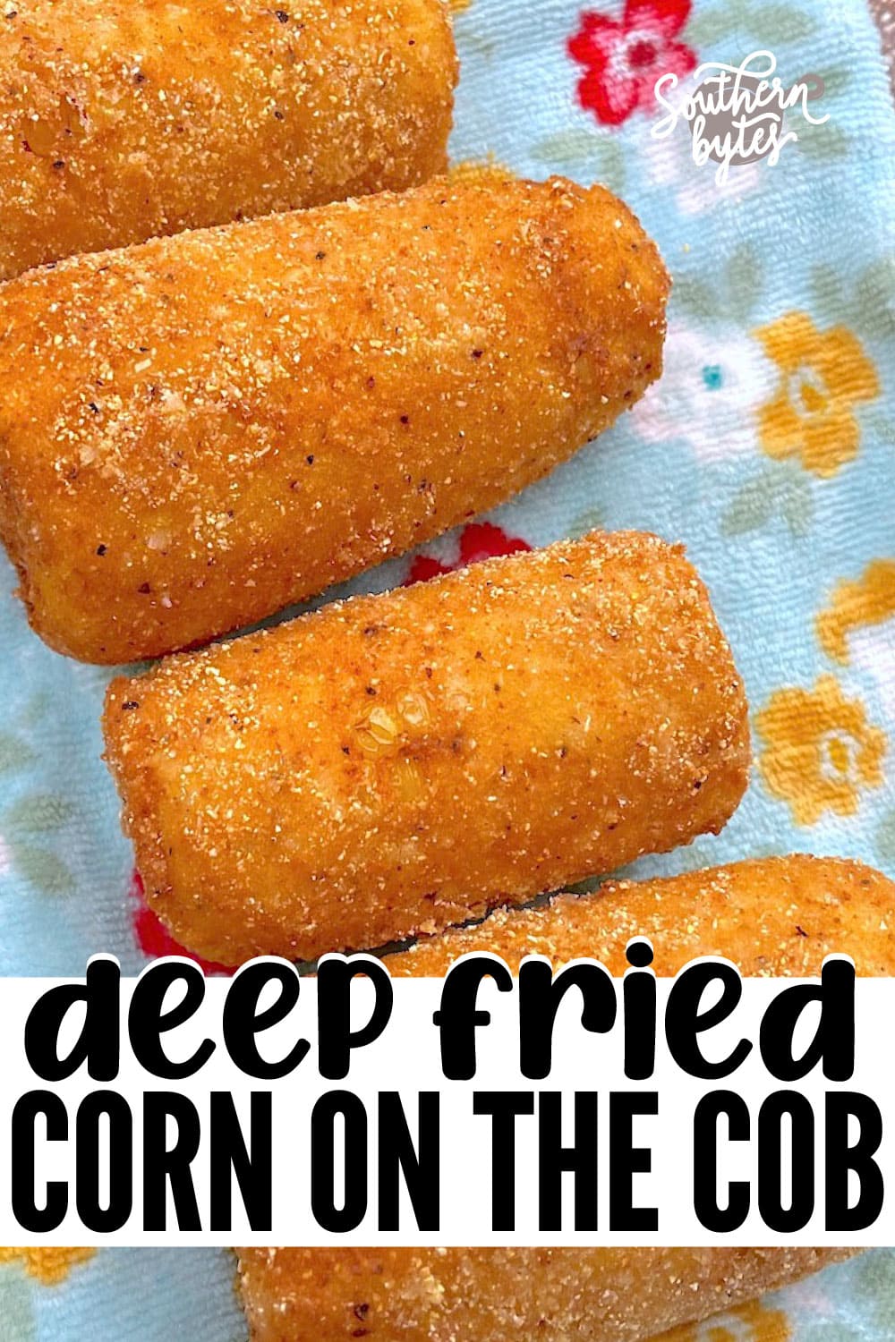 A pin image of four pieces of fried corn on the cob on a blue towel on a plate.