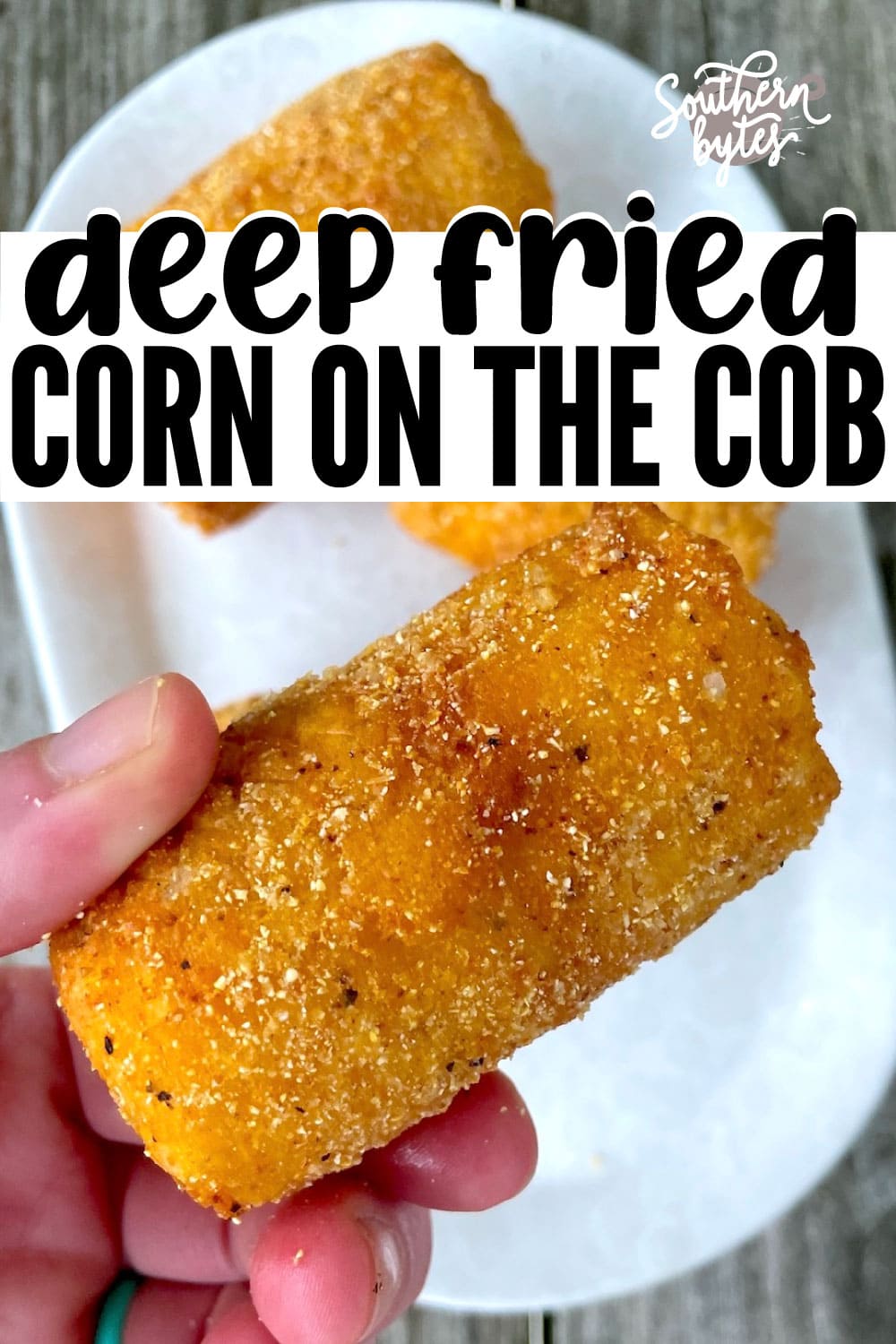 A pin image of a hand holding a piece of fried corn on the cob over a white plate.