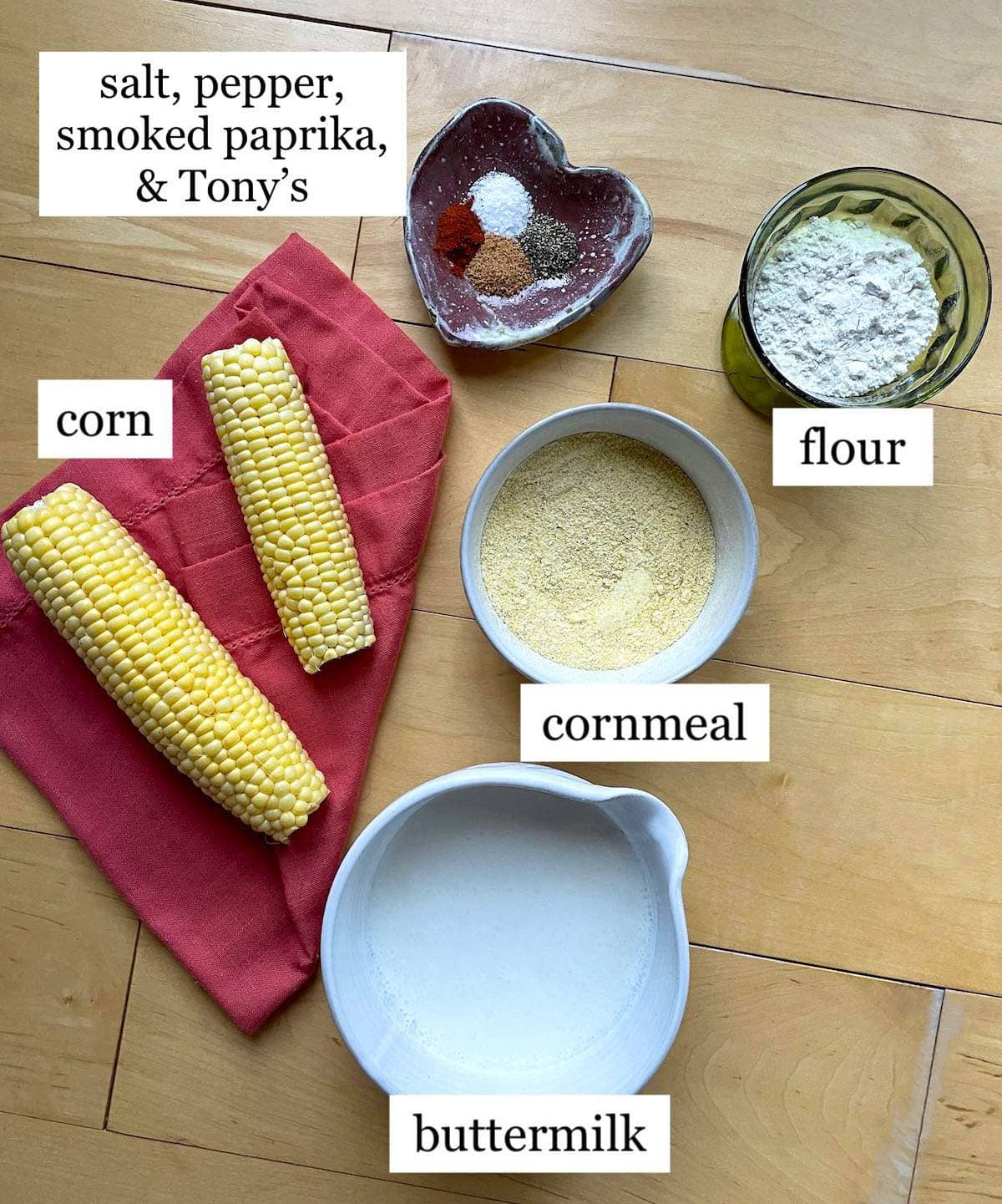 The ingredients needed to make fried corn on the cob laid out in bowls.