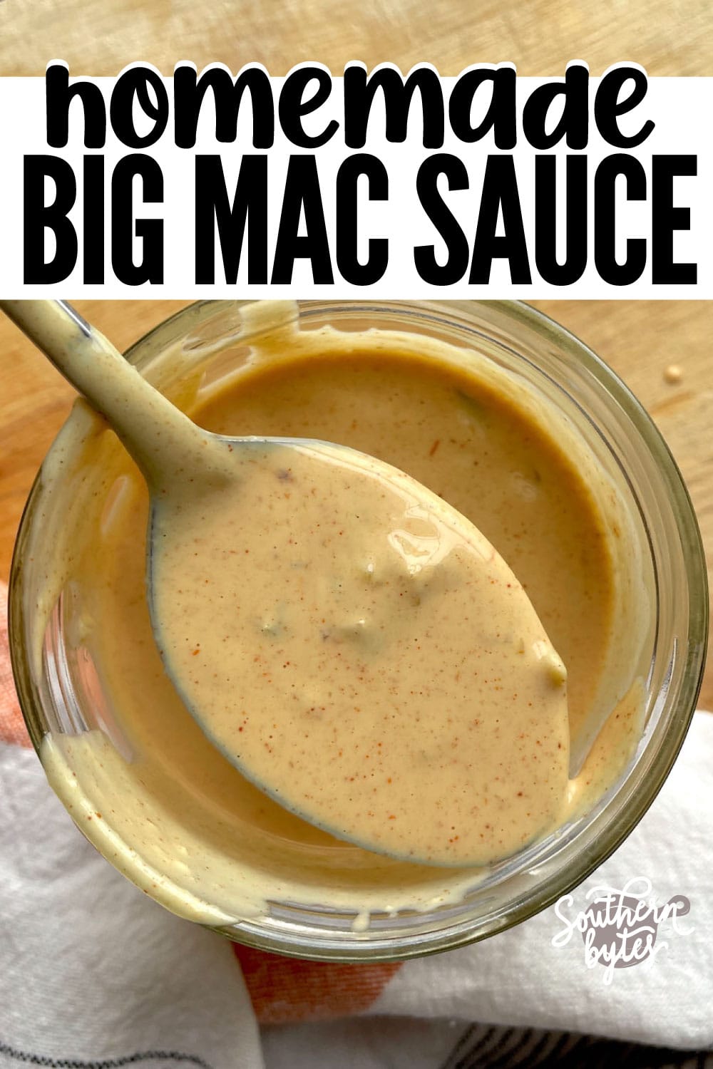 A spoon of Big Mac Burger Sauce over a jar of the sauce drizzling back into the jar.