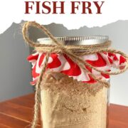 A pin image of a jar of homemade cornmeal fish fry mix with a bow tied around it.