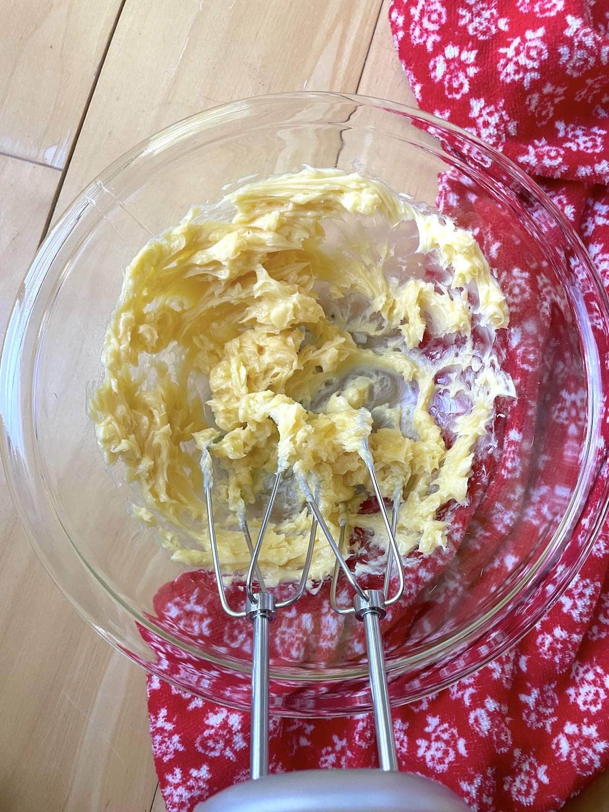 Honey butter in a mixing bowl after being whipped with a hand mixer.