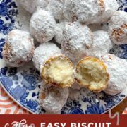 A pin image of a blue plate with biscuit beignets on it, covered in powdered sugar, with one split open on the top.