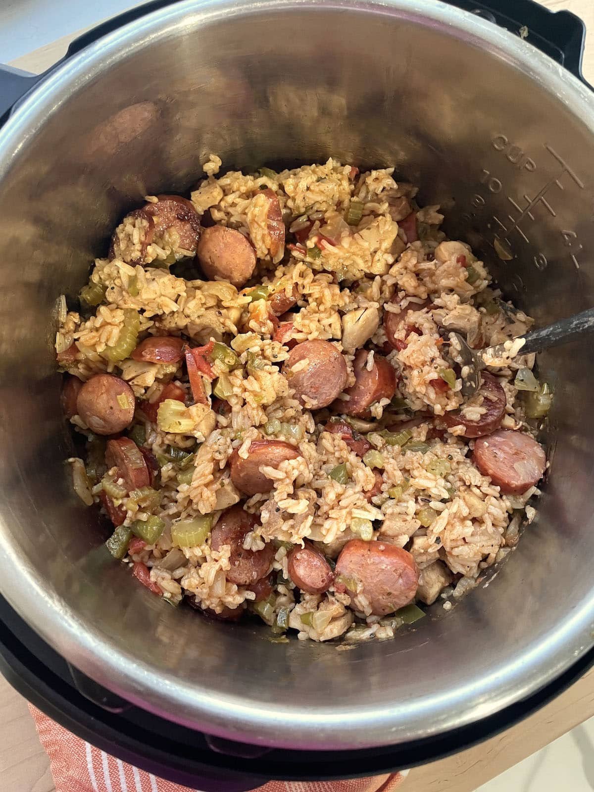 An instant pot with cooked jambalaya and fluffed rice in it.