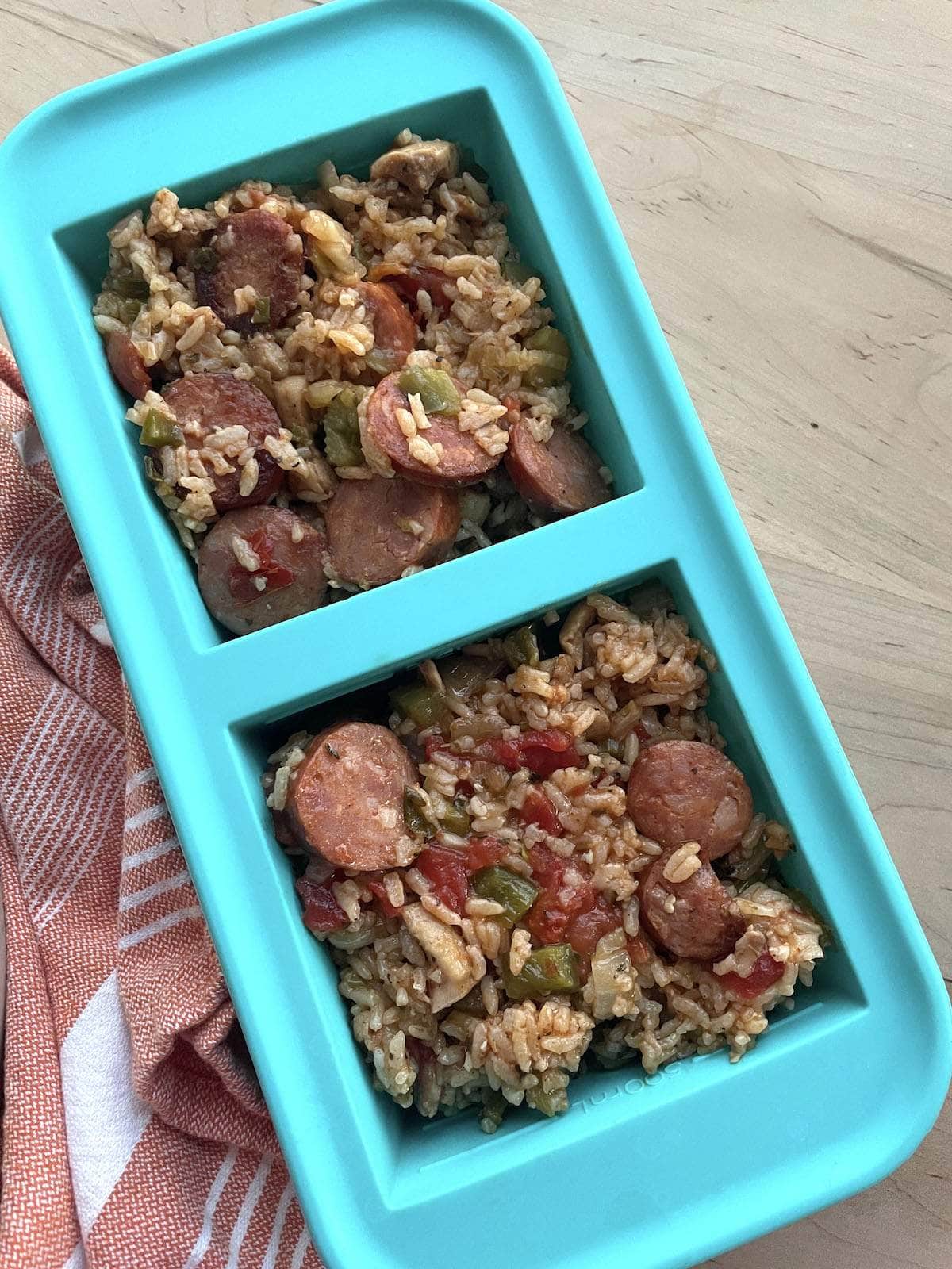 A two cup Souper cube container filled with leftover chicken and sausage jambalaya.