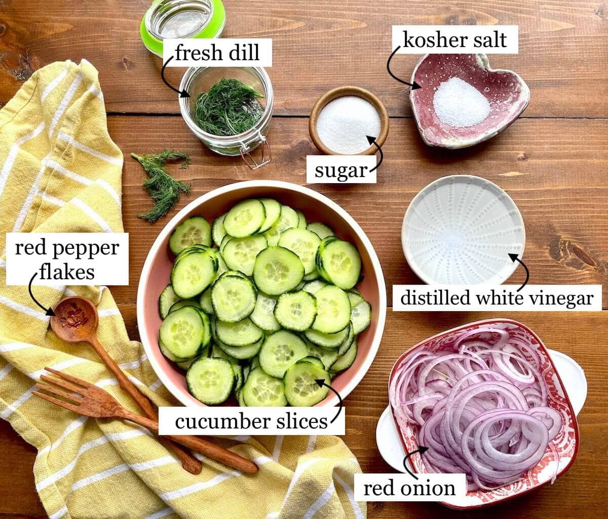 The ingredients in pickled cucumber salad laid out and labeled.