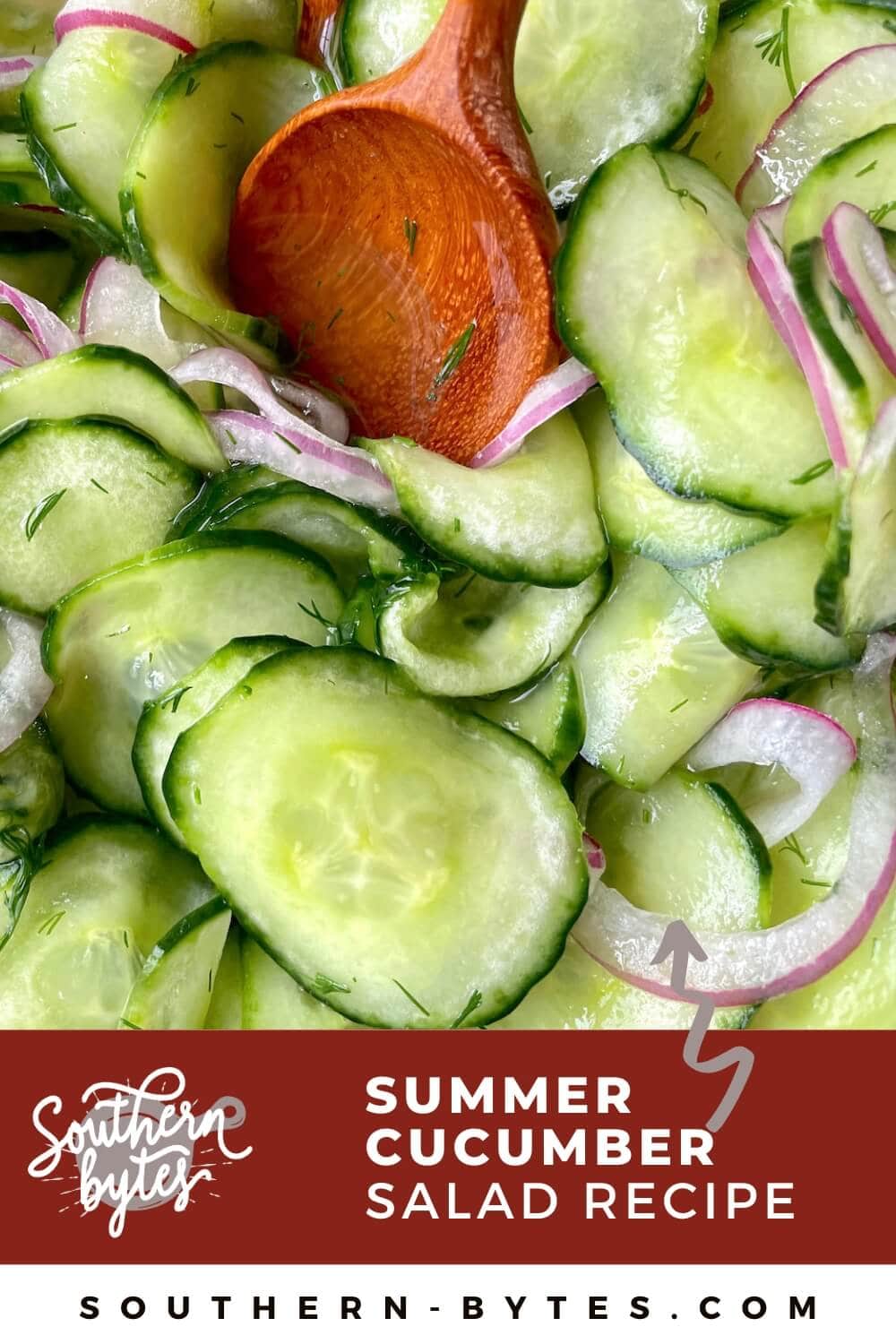 A pin image of pickled cucumber salad with red onions being mixed by a wooden spoon.