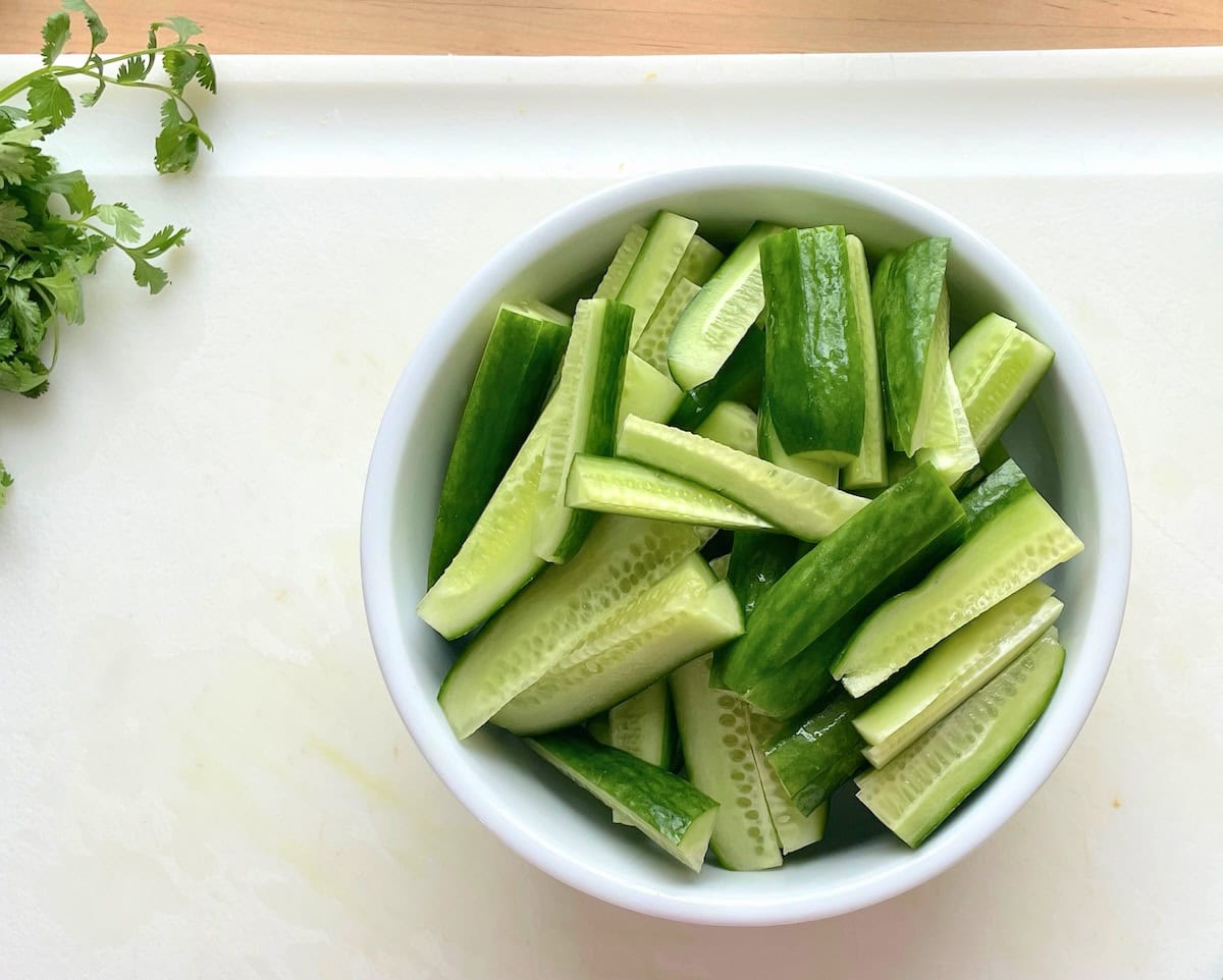 A bowl of Persian cucumbers sliced into spears to make quick Korean pickles.