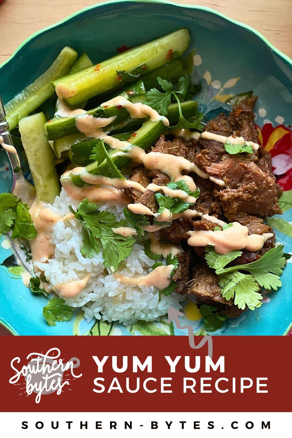 A pin image of a blue bowl with rice, bulgogi, Korean pickles, Yum Yum sauce, and cilantro, focused on the Yum Yum Sauce.