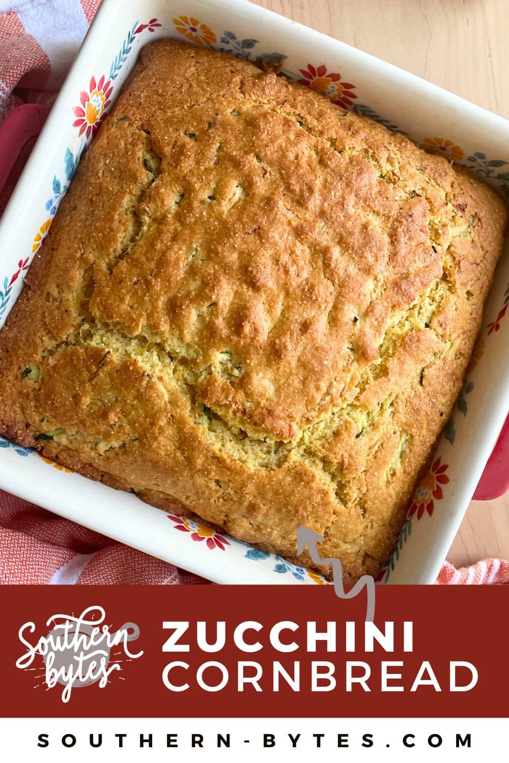 A pin image of a square white baking dish with baked zucchini cornbread in it.