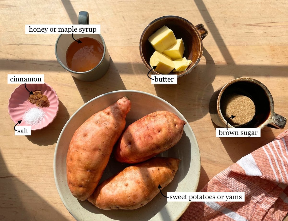 Ingredients for crockpot candied sweet potato laid out, including sweet potatoes, butter, brown sugar, cinnamon, salt, and honey or maple syrup.