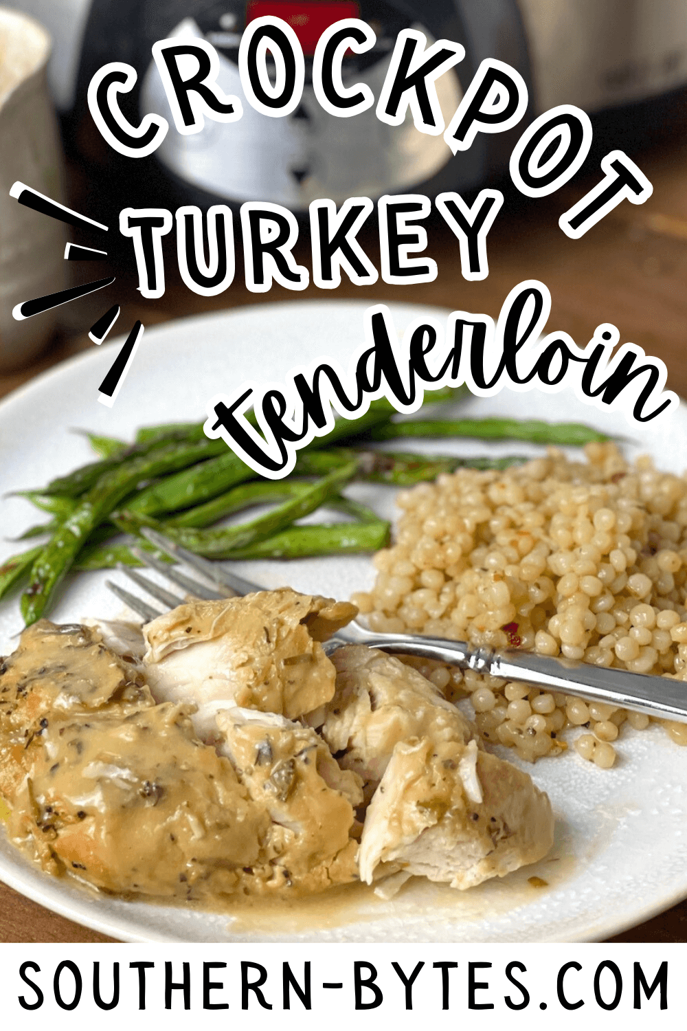 A pin image of a plate of crockpot turkey tenderloin served with asparagus and couscous.