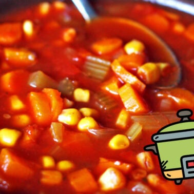 Close-up of a hearty vegetable stew with carrots, celery, corn, and potatoes in a tomato-based sauce.