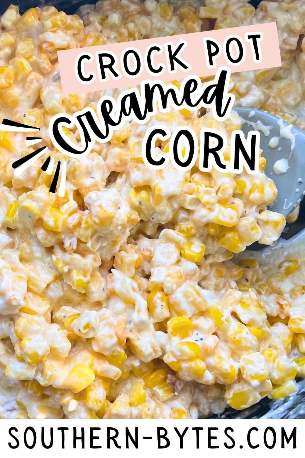 A pin image of a close-up of a creamy crock pot creamed corn dish.