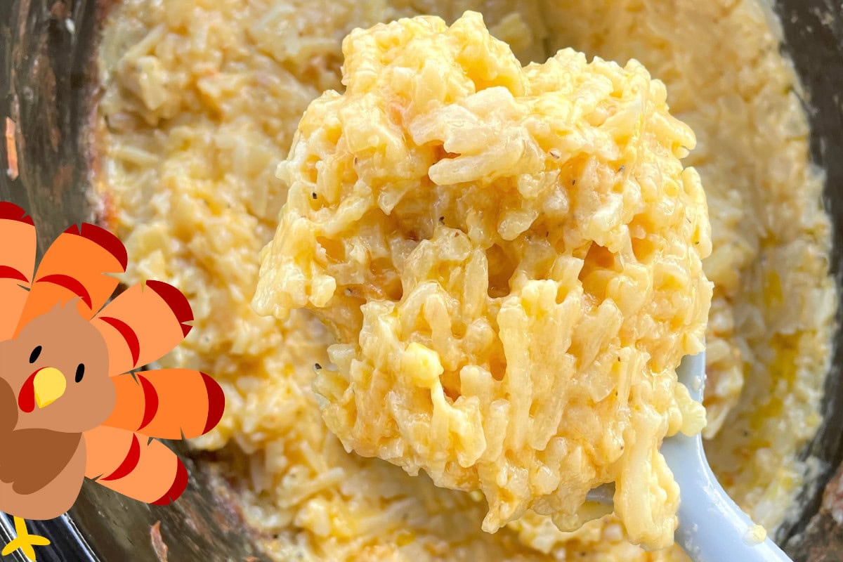 Close-up view of a spoonful of creamy macaroni and cheese with melted cheddar.