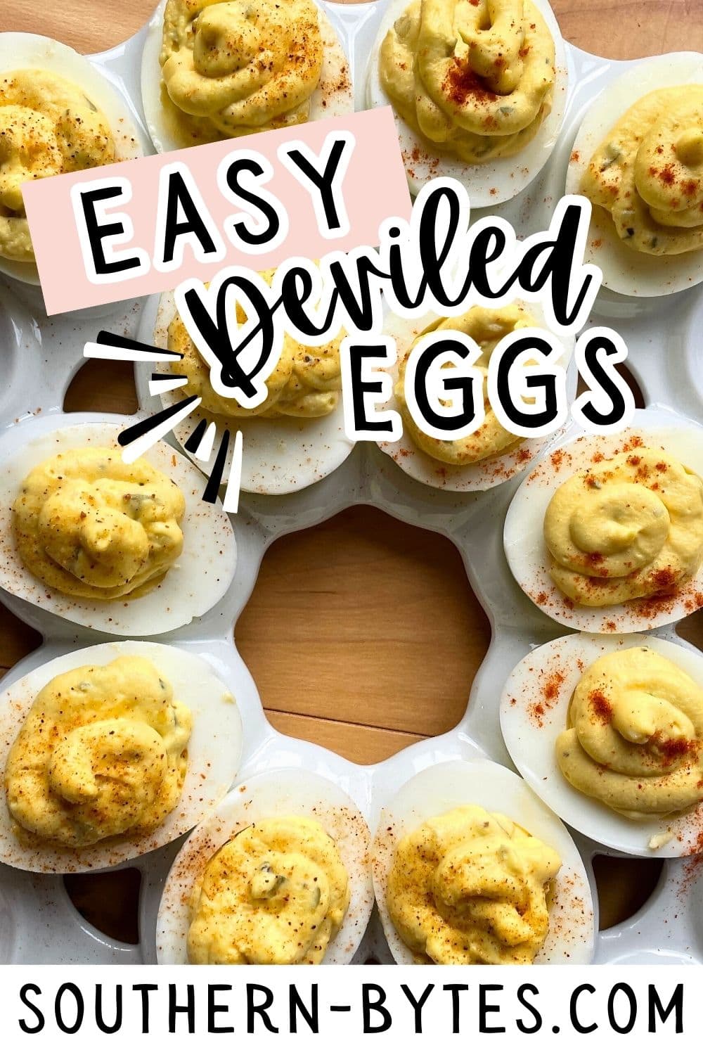 A pin image of a plate of deviled eggs with sprinkled with Creole seasoning and paprika.