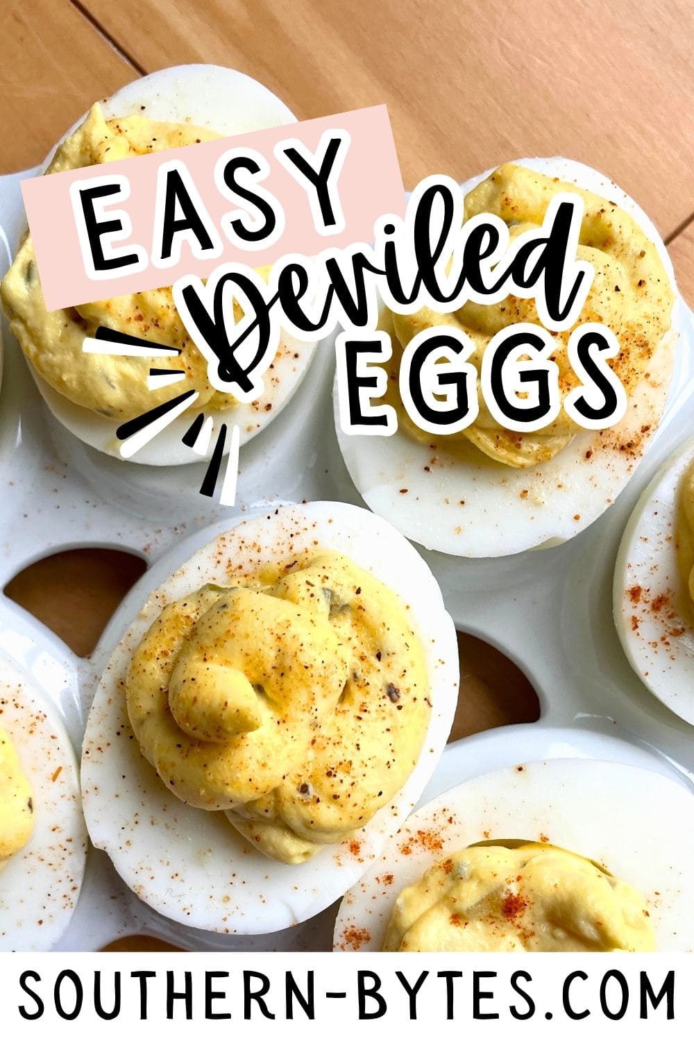 A pin image of a plate of deviled eggs sprinkled with Cajun seasoning.