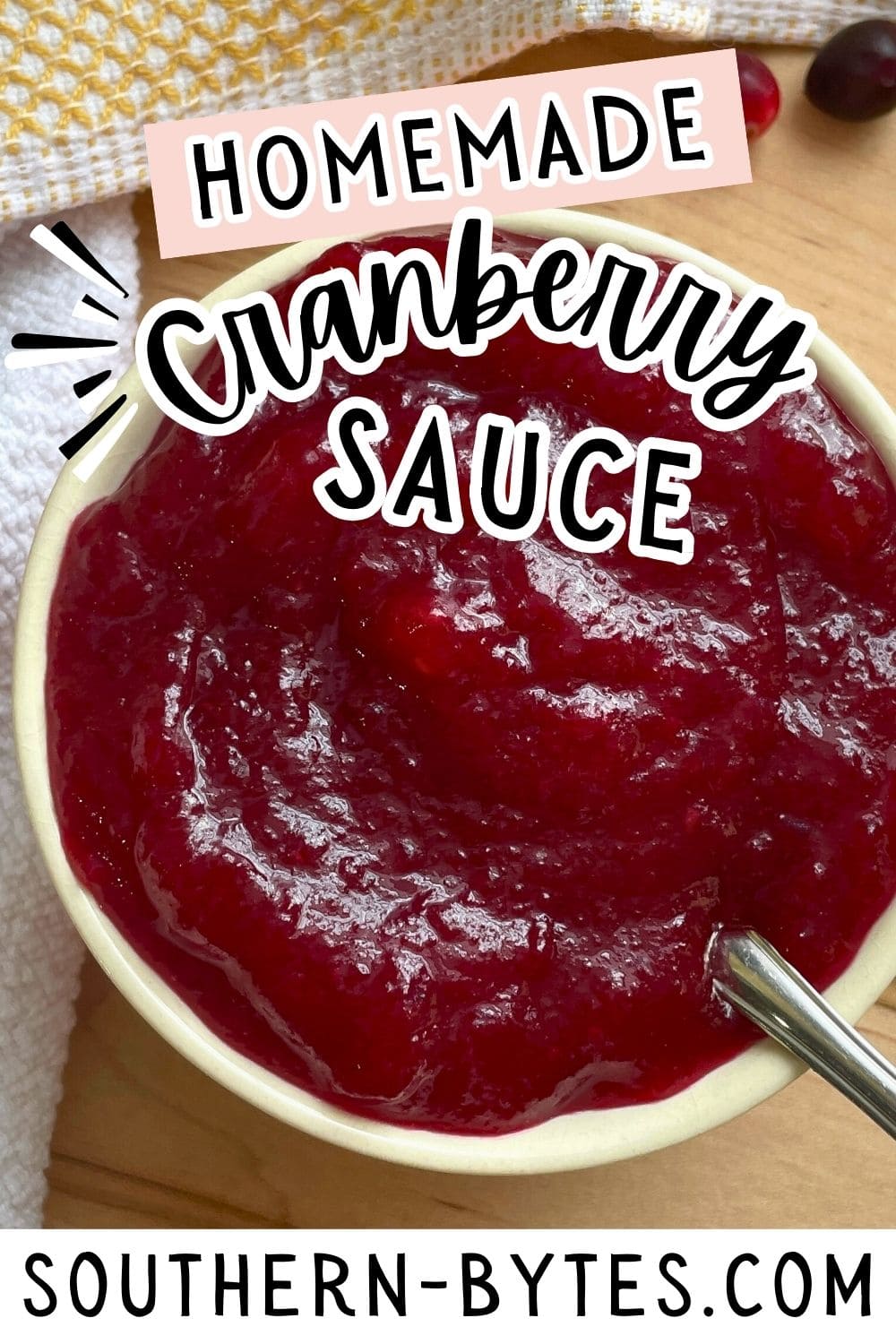 A pin image of a bowl of homemade cranberry sauce with a spoon.