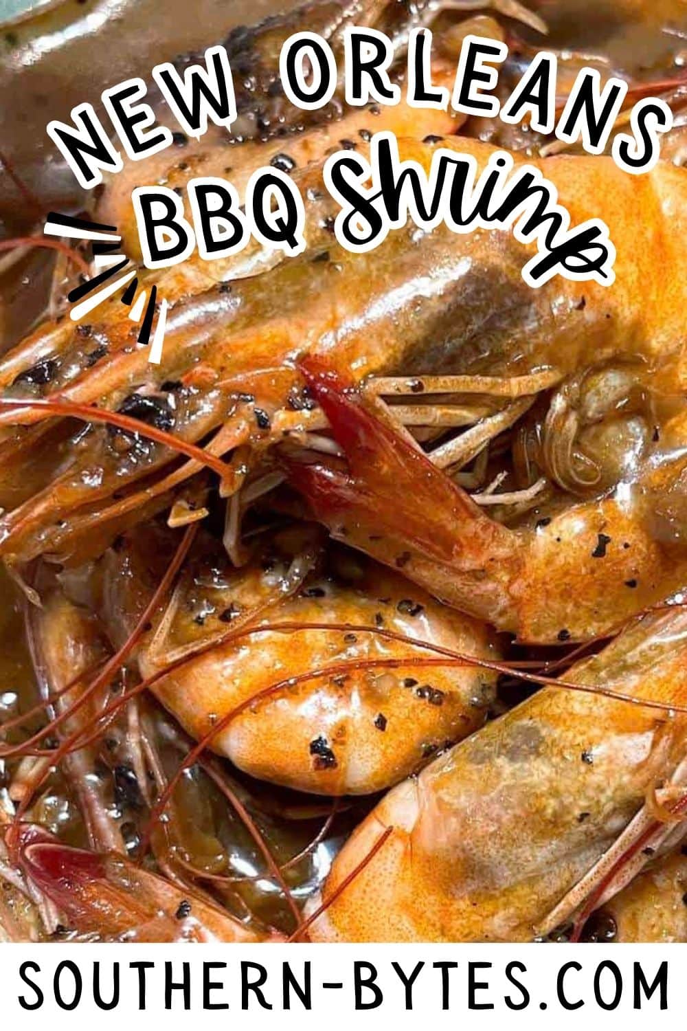 A pin image of a close-up of New Orleans BBQ shrimp garnished with herbs and spices from Southern-Bytes.com.