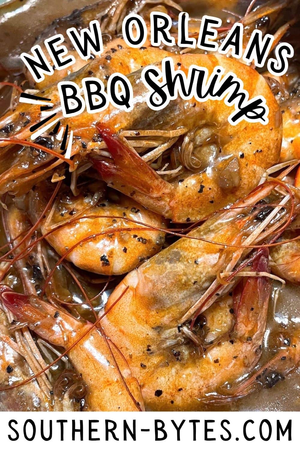 A pin image of a close-up of New Orleans BBQ shrimp in sauce from Southern-Bytes.com.