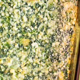 A pan of spinach and artichoke casserole.