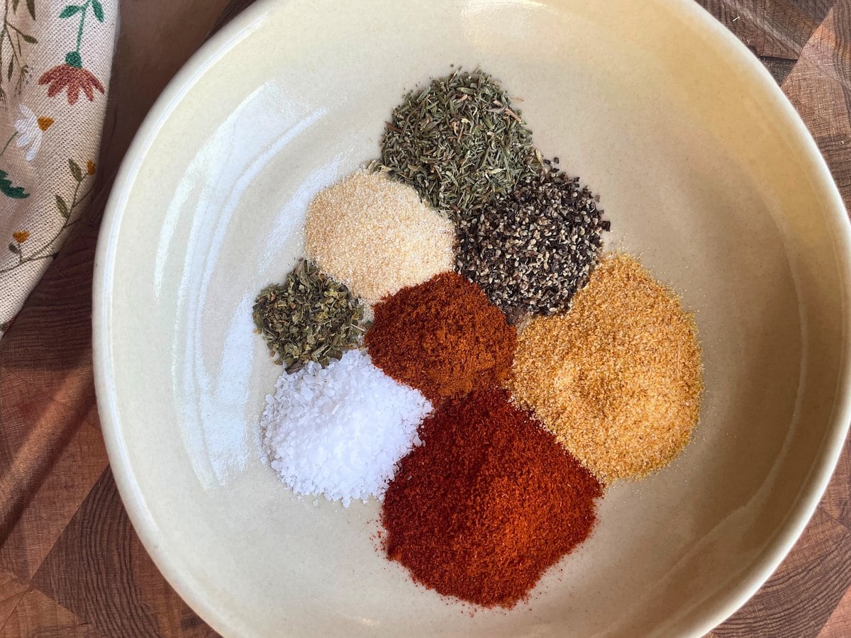 The spices and herbs in a Cajun blackening seasoning blend laid out in a bowl.