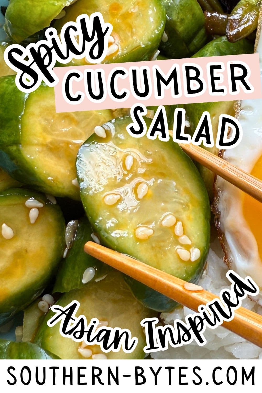 A pin image of spicy cucumber salad topped with sesame seeds held with chopsticks.